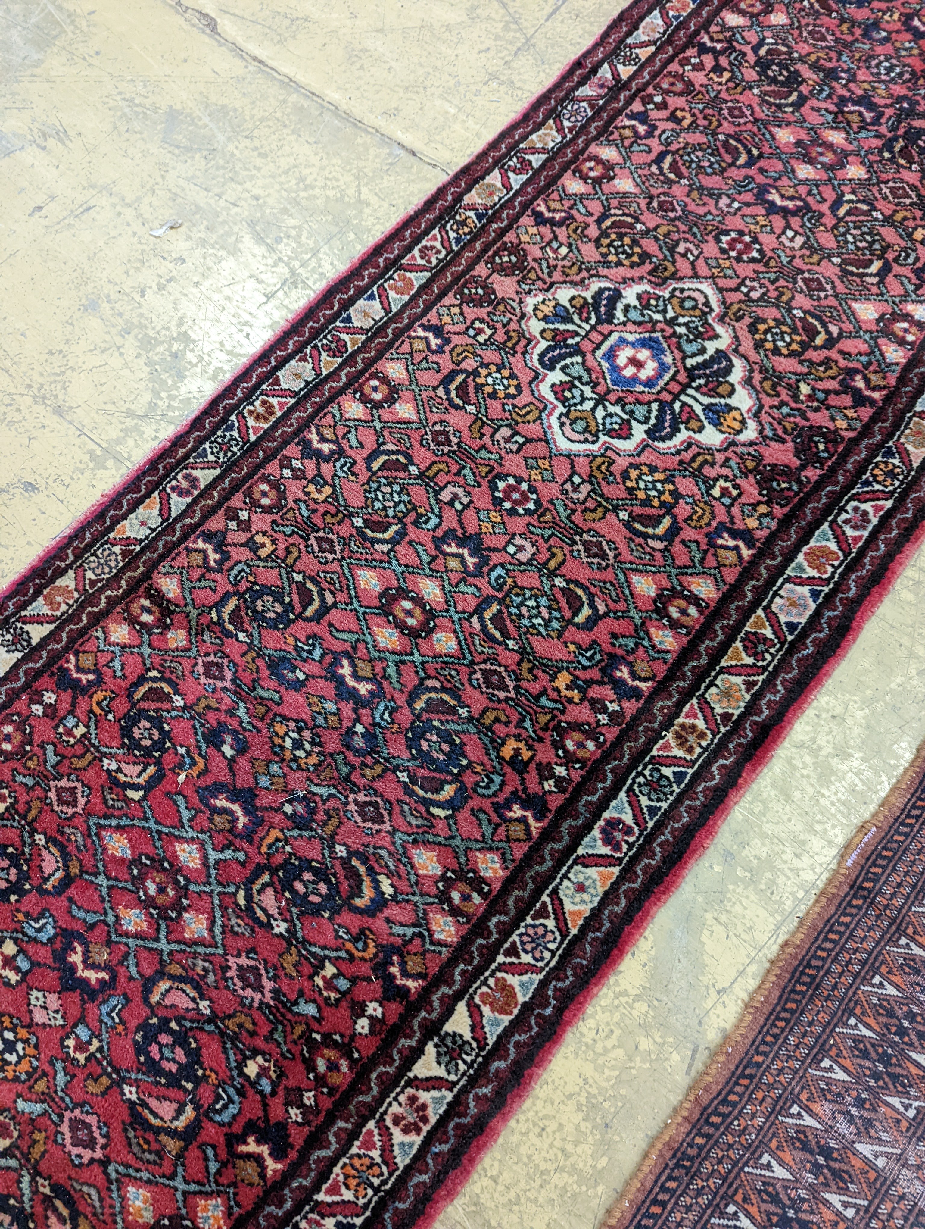 A North West Persian red ground runner and a Bokhara runner, larger approx. 290 x 78cm